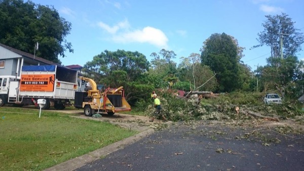 The chipper and crew working through cut branches